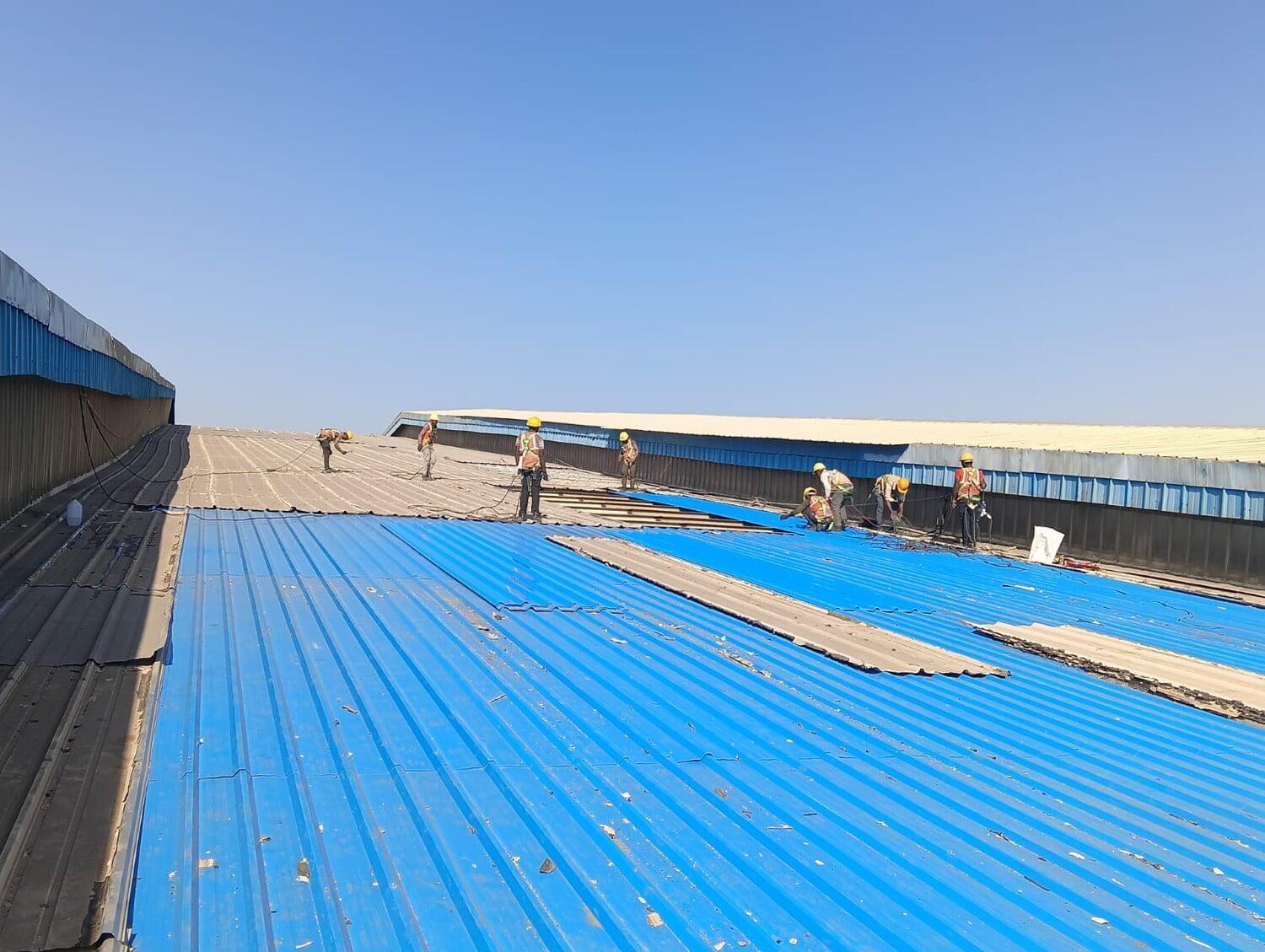 Commercial architectural roofing at Oberoi Mall, Mumbai: Specialized Kliplok roof-on-roof installation by Rishonn & Reyansh for leak-proof retail infrastructure.